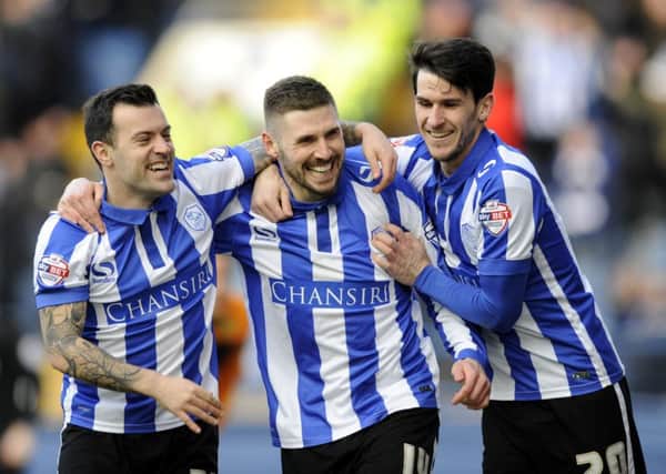 Gary Hooper celebrates with Ross Wallace and Kieran Lee.