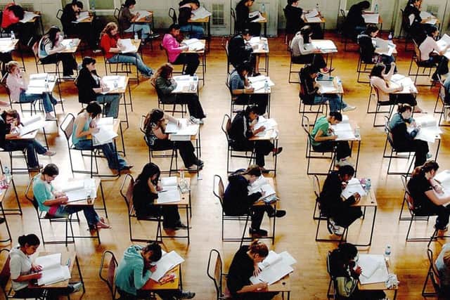 Students sitting exams. Turning schools into academies will feature in the Queen's Speech, but blanket conversion plans have been dropped.  Rui Vieira/PA Wire