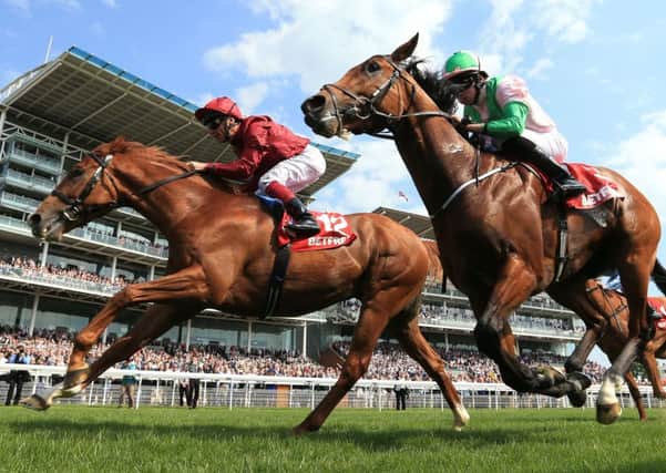 Frankie Dettori, on board Wings of Desire, (left) beats Deauville ridden by Ryan Moore to win The Betfred Dante Stakes at York Racecourse. Picture: Mike Egerton/PA Wire