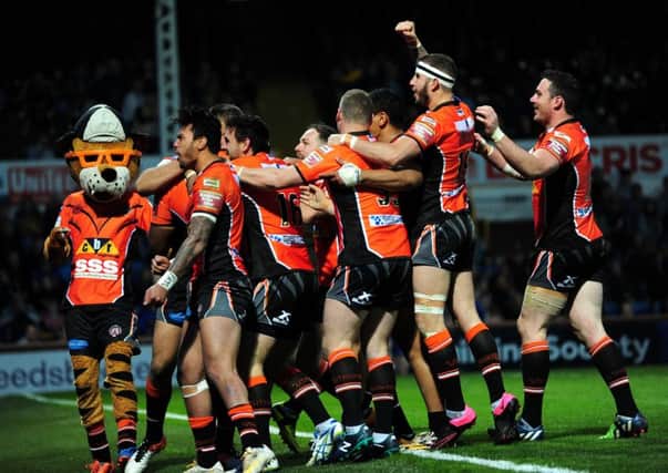 Castleford Tigers players mob Gadwin Springer after his try (Picture : Jonathan Gawthorpe).