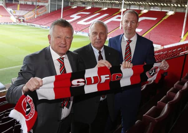 Chris Wilder, the new manager of Sheffield United, with co-owner Kevin McCabe and Alan Knill, assistant manager.