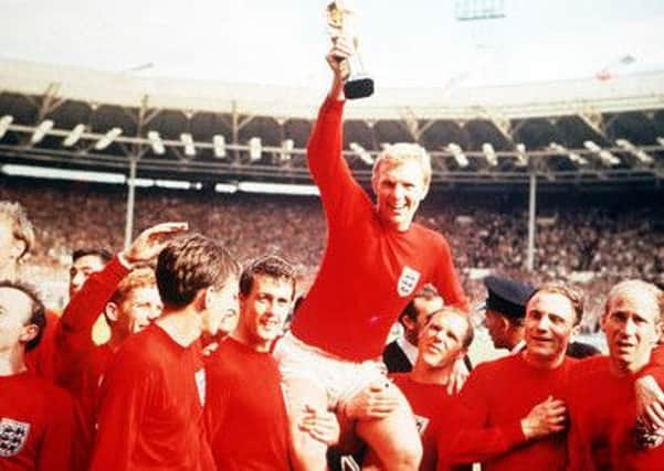 England captain Bobby Moore holds aloft the Jules Rimet World Cup trophy as he sits on the shoulders of his teammates after the 1966 World Cup final.