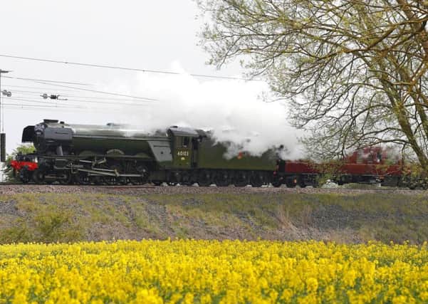 The Flying Scotsman passes a rapeseed field near Durham, as part of its UK tour.