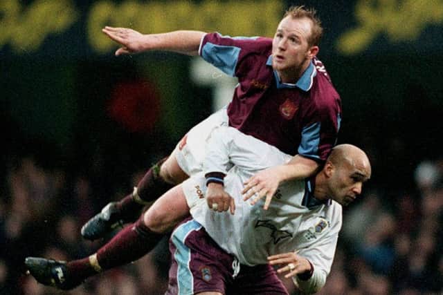 Emley's goal scorer Paul David gives a ride to West Ham goal scorer John Hartson.