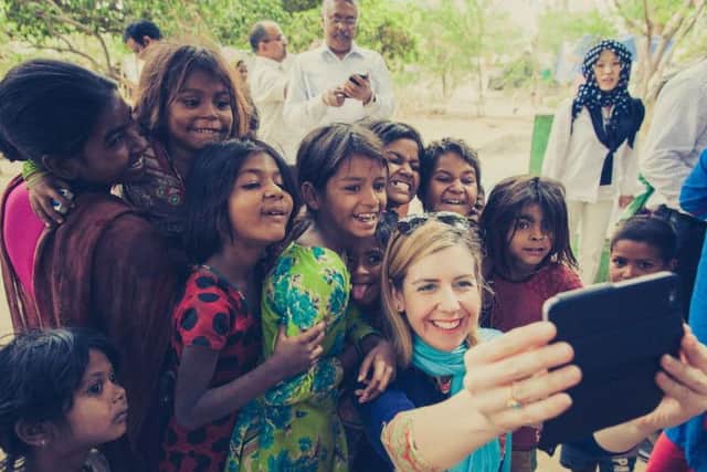 Andrea Jenkyns photographed with children from a nomadic community in Uttar Pradesh.