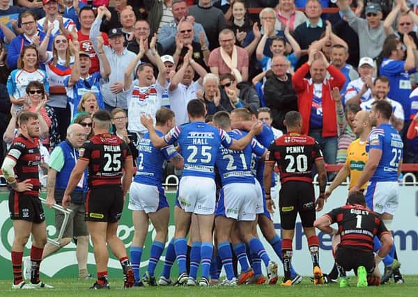 JOB DONE: Wakefield's players celebrate at the end of their victory over Warrington. Picture: Dave Williams.