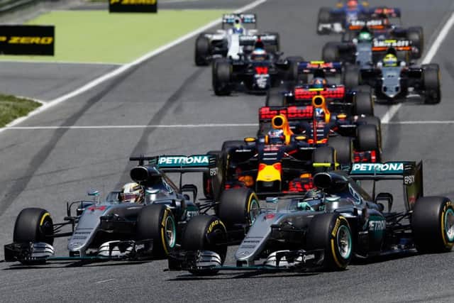 COLLISION COURSE: Mercedes drivers Lewis Hamilton, foreground left, and Nico Rosberg, right, enter the first curve at the Barcelona Catalunya racetrack. Picture: AP.