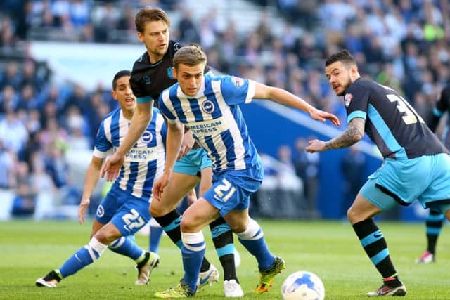Brighton and Hove Albion's James Wilson (centre) and Sheffield Wednesday's Glenn Loovens (left) battle for the ball during the Sky Bet Championship play off, second leg
