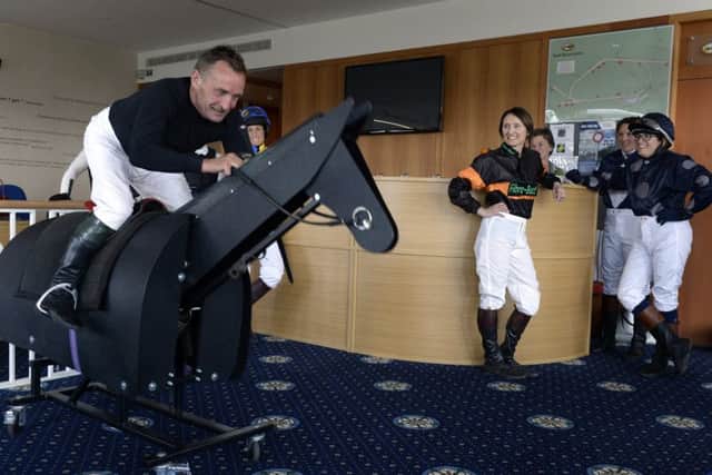 Owen Dukes from Malton gets to grips with the mechanical horse in the weighing room at York Racecourse during the training session with Kevin Darley.