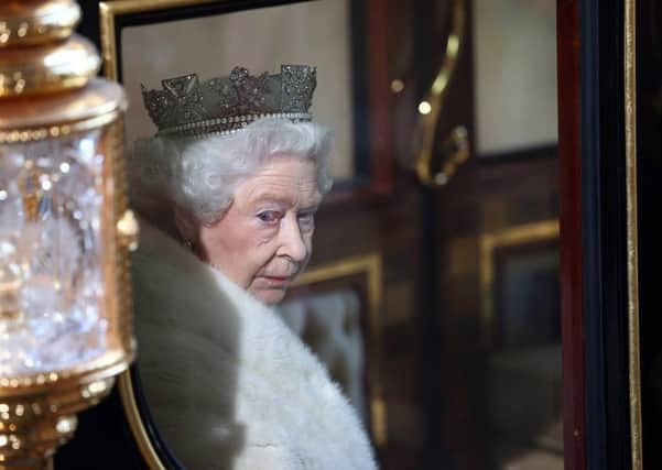 Queen Elizabeth II looks out from her carriage as she leaves the Palace of Westminster in London, following the State Opening of Parliament. PRESS ASSOCIATION Photo. Picture date: Wednesday May 27, 2015. See PA story POLITICS Speech. Photo credit should read: Carl Court/PA Wire