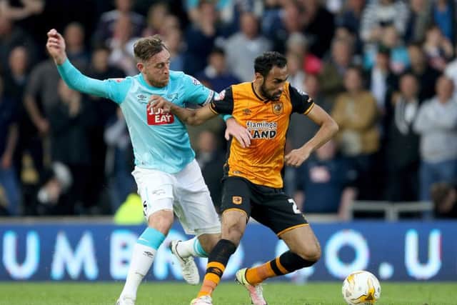 Hull City's Ahmed Elmohamady (right) holds off Derby County's Richard Keogh at the KC Stadium. Picture: Richard Sellers/PA