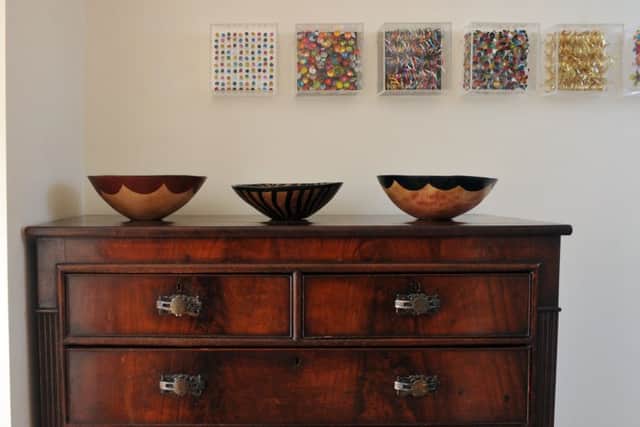 The chest of drawers belonged to Joanne's grandmother and the bowls are from South Africa. Her art work is framed above