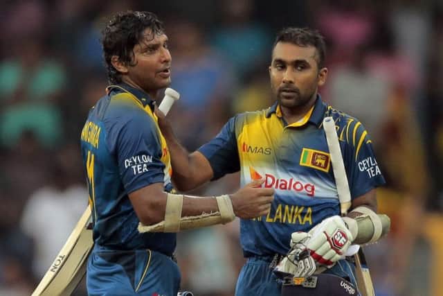 Sri Lankan batsmen Kumar Sangakkara, left, and Mahela Jayawardene congratulate each other during a one-day international against England in Colombo, Sri Lanka in November 2014.  Picture: AP/Eranga Jayawardena.