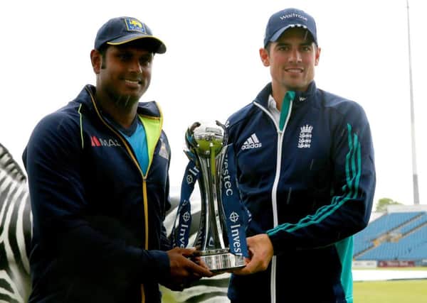 Sri Lanka captain Angelo Mathews and England counterpart Alastair Cook pose for a photo with the Investec Trophy at Headingley. Picture: Simon Cooper/PA
