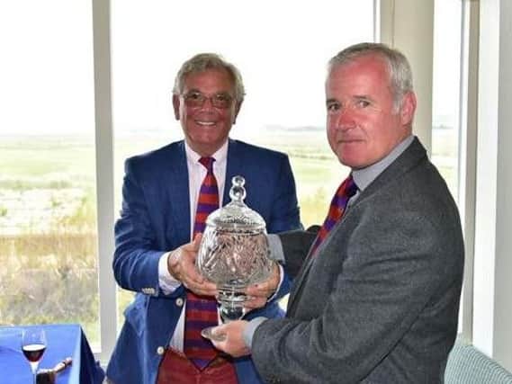 Headingley GC secretary Jon Hall receives his prize at Royal West Norfolk GC.