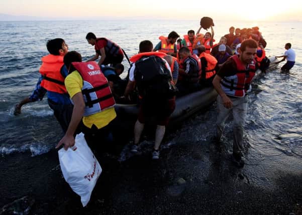 Migrants and refugees in a rubber dinghy arriving on the beach at Psalidi near Kos Town, Kos, Greece, as Interpol has warned that 800,000 migrants are waiting in Libya to try and make the crossing to Europe.  A joint report by the crime fighting organisation, and its European counterpart, Europol, was seized on by Leave campaigners.