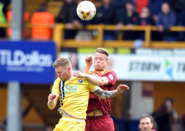 Bradford City 's Nathan Clarke outjumps Millwall's Aiden O'Brien.  Picture: Tony Johnson