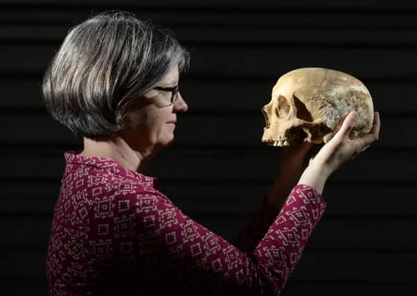 Dr Jane Richardson with a skull found during the dig in Leeds at the site of the Victoria Gate development.
Picture: Bruce Rollinson