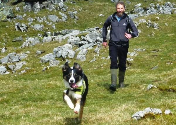 Trainee search dog Angus with Bill Batson.