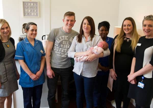 Liam and Ami Duggleby pictured with their newborn daughter April Grace and the neonatal team at Leeds General Infirmary after handing over Â£14,000.