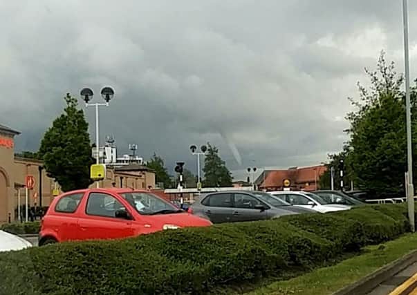 This is the rare moment a mini TWISTER was spotted circling across the skies of a sleepy English town.  See NTI story NTITWISTER.  The unusual weather phenomenon is more commonly spotted in areas of North America.  But shocked locals noticed the strange sight in the market town of Spalding, Lincs., on Wednesday (18/5) night.  Eyewitness George Power spotted the funnel cloud with his son Freddie, eleven, as they approached the town from Sutterton, Lincs., along the A16.