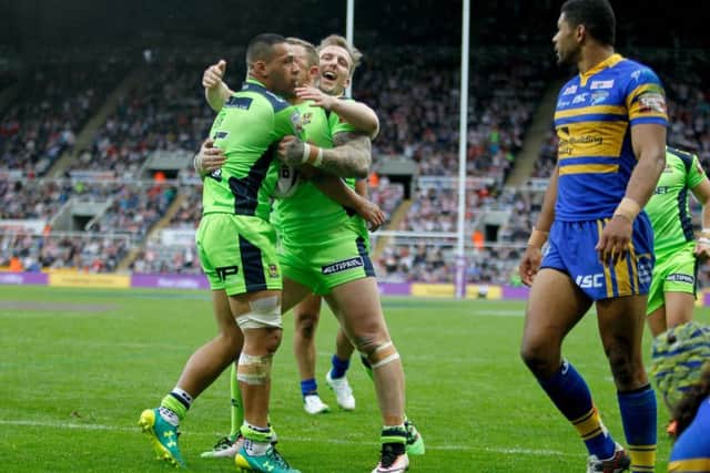 Wigan Warriors players celebrate after Willie Isa (left) scores a try. Picture: Richard Sellers/PA