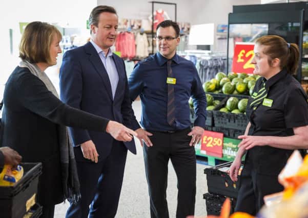 Prime Minister David Cameron and former Deputy Labour Leader Harriet Harman speak to Asda employees as they visit an Asda supermarket in Hayes, London. PIC: PA