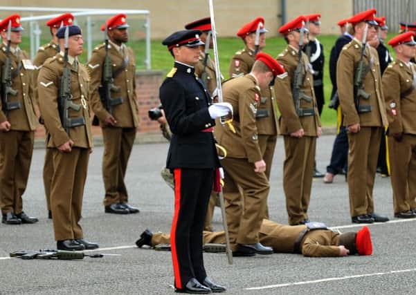 A  soldier from The Light Dragoons  faints during the  Tercentenary parade.