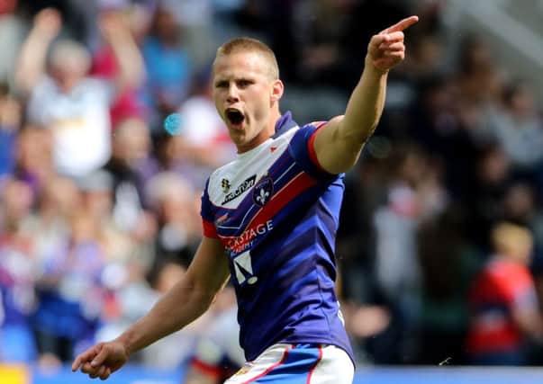 Jacob Miller celebrates his match-winning drop goal for Wakefield against Catalans Dragons.