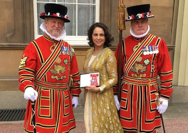 Adeeba Malik with her CBE following a ceremony at Buckingham Palace presided over by the Prince of Wales.