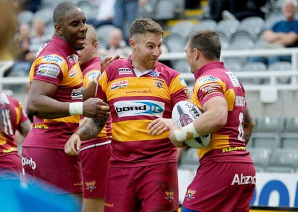 Huddersfield Giants' Michael Lawrence (left)Jamie Ellis (centre) and Danny Brough celebrate a try during their Magic Weekend clash with St Helens. Picture: Richard Sellers/PA