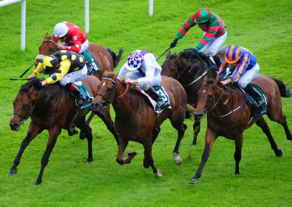 Mobsta ridden by Pat Smullen (black & yellow) wins the Weatherbys Ireland Greenlands Stakes ahead of Flight Risk ridden by Kevin Manning (white & purple) in second and Dick Whittongton ridden by Ryan Moore (blue & orange) in third during day one of the Tattersalls Irish Guineas festival, at the  Curragh. Picture: PA.