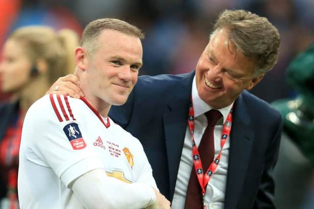 Manchester United manager Louis van Gaal (right) celebrates winning the FA Cup with Wayne Rooney (left). Picture: Mike Egerton/PA