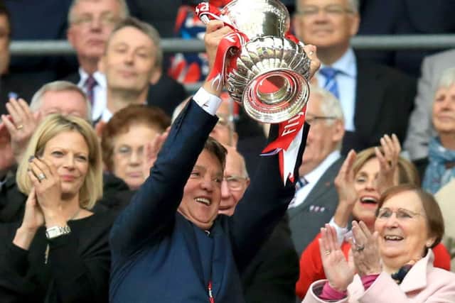 Manchester United manager Louis van Gaal lifts the FA Cup at Wembley on Saturday. Picture: Mike Egerton/PA in betting, games or single club/league/player publications.
