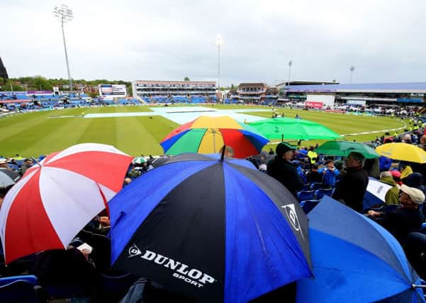 WEATHER-WATCH: Umbrellas went up at Headingley as rain stopped play during the third day of the first Test between England and Sri Lanka. The delay failed to save the tourists, who lost by an innings and 88 runs to Alastair Cooks side. Picture: Nigel French/PA
