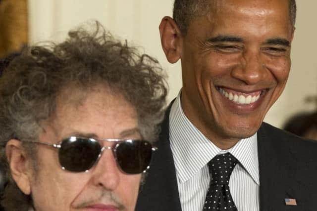 President Barack Obama smiles as he awards the Medal of Freedom to Bob Dylan in 2012. (AP Photo/Carolyn Kaster)