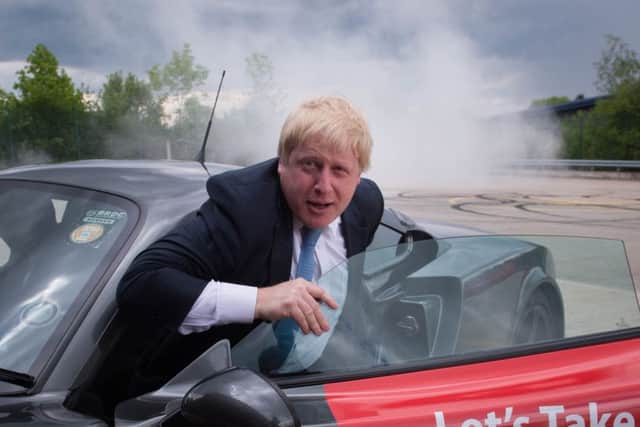 Boris Johnson, emerges from a Ginetta sport car after the company's Chief Executive, Lawrence Tomlinson, performed a series of  'doughnuts' as the former Mayor of London visited the factory in West Yorkshire, as part of his tour on the Vote Leave campaign bus. PRESS ASSOCIATION Stefan Rousseau/PA Wire