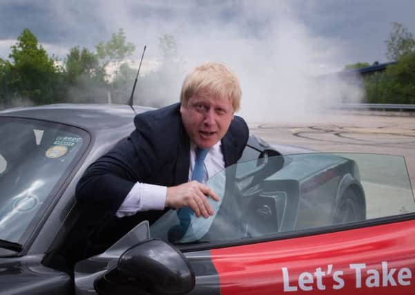 Boris Johnson, emerges from a Ginetta sport car after the company's Chief Executive, Lawrence Tomlinson, performed a series of  'doughnuts' as the former Mayor of London visited the factory in West Yorkshire, as part of his tour on the Vote Leave campaign bus. PRESS ASSOCIATION Stefan Rousseau/PA Wire