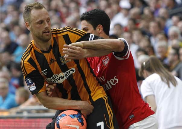 Hull City's David Meyler holds on to the ball as Arsenal's Mikel Arteta tries to retrieve it during the FA Cup Final at Wembley Stadium, London.