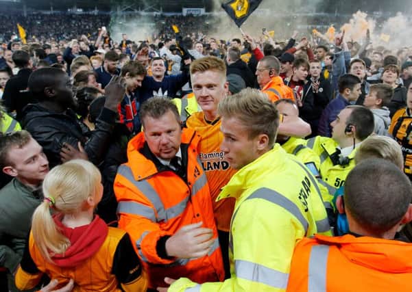 Sam Clucas is escorted away as Hull City fans celebrate overcoming Derby County to reach the Championship play-off final.
