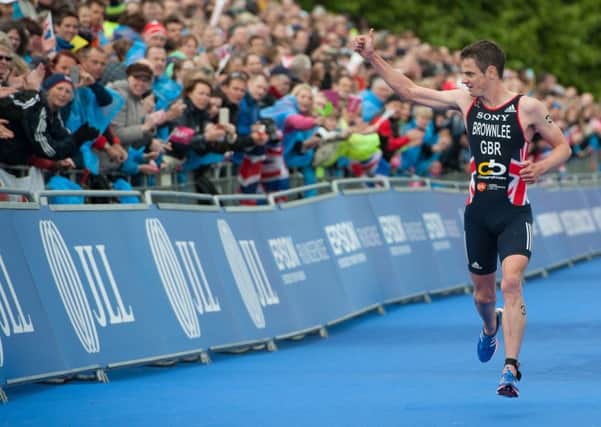 Jonathan Brownlee passes the grandstand at the Vitality World Triathlon London 2015.
