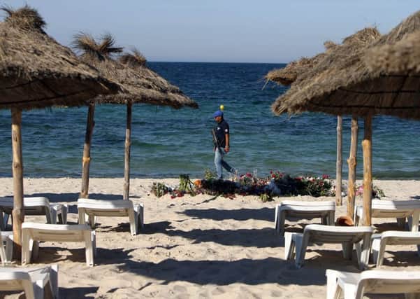 An armed policeman on the beach near the RIU Imperial Marhaba hotel in Sousse, Tunisia, following last year's terrorist attack at the beach.