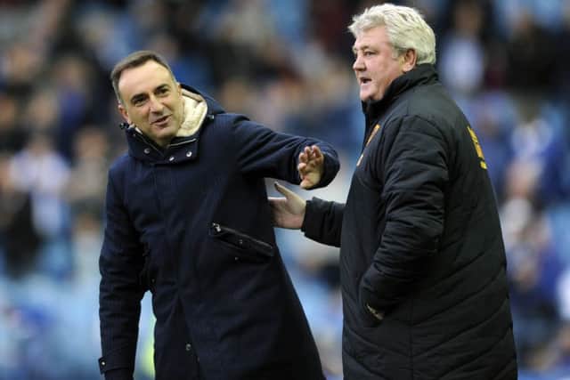 Carlos Carvalhal and Steve Bruce at the final whistle after the 1-1 draw at Hillsborough. Picture: Steve Ellis.