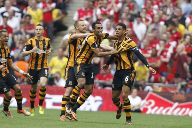 Hull City's Curtis Davies (right) celebrates scoring his side's second goal against Arsenal during the 2014 FA Cup Final at Wembley against Arsenal. Picture: Peter Byrne/PA.
