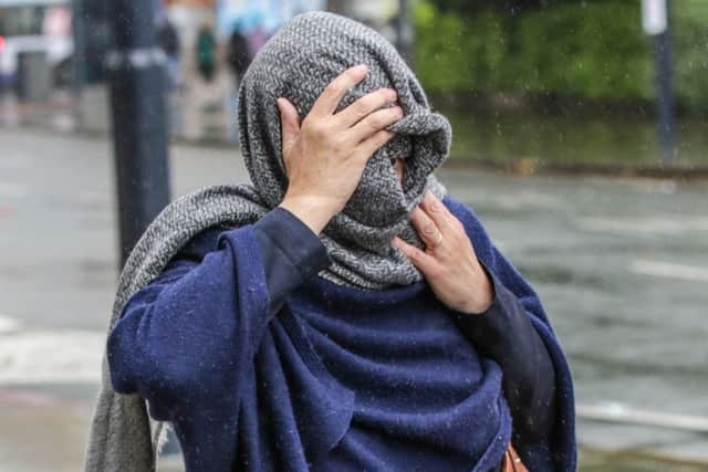 Maxine Forster, 51, hides her face as she leaves Bradford Crown Court. Picture: Ross Parry Agency