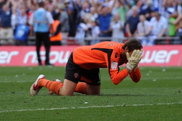 Sheffield United's goalkeeper, Steve Simonsen, slumps to the ground after missing the crucial penalty in 2012's infamous shoot-out loss to Huddersfield Town.
 Picture: Jonathan Gawthorpe.
