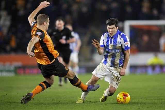 Hull City's Michael Dawson challenges Sheffield Wednesday's Fernando Forestieri resulting in the latter getting a second yellow card for diving and being sent off.