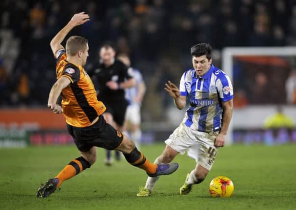Hull City's Michael Dawson challenges Sheffield Wednesday's Fernando Forestieri resulting in the latter getting a second yellow card for diving and being sent off.