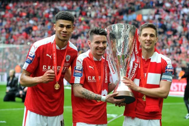 Adam Hammill, centre, with Ashley Fletcher, left, and Conor Hourihane after Barnsley's Johnstone's Paint Trophy triumph (Picture: Tony Johnson).