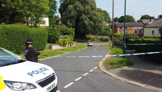 Police at the scene in Wadsley Lane, near the junction with Braemoor Road, South Yorkshire, as a teenager has been arrested following the death of an 18-year-old man.